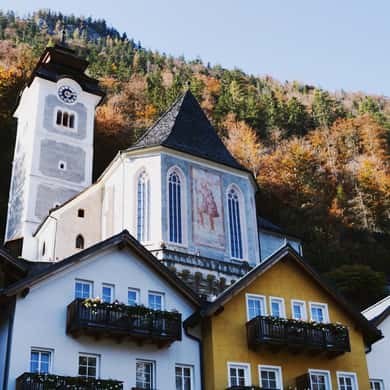 The parish church's white tower and painted gable above the roofs