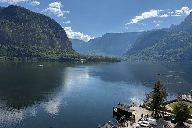 The lake between steep wooded mountains, seen from above the village