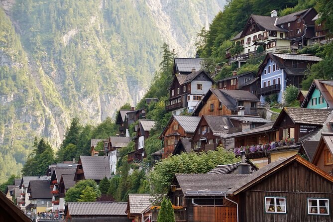 Timber houses stacked up the steep slope above the water