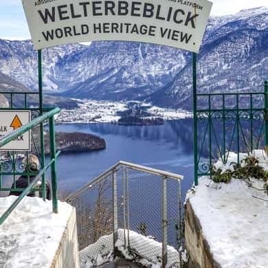 The World Heritage View sign at the top of the platform steps, above the lake in snow